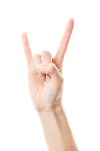 Female hand isolated on white background. White woman's hand showing symbols and gestures. Woman's hand showing Rock gesture isolated on white. Rock'n'roll symbol.