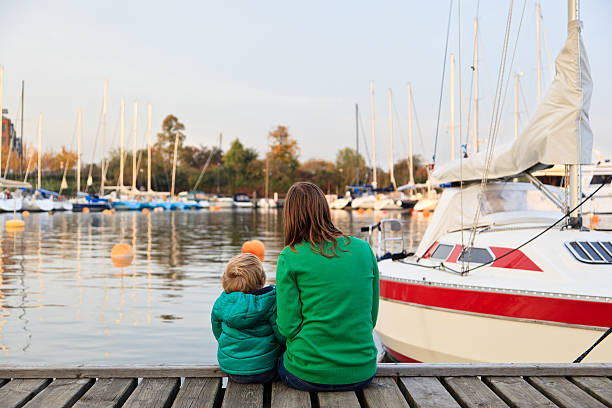 istock family sitting on pier 157624081