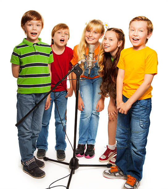 istock Group of kids singing to microphone 157624394
