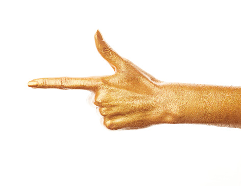 Hands in gold paint. Golden fingers. Female hand isolated on white background. White women's relaxed hand showing symbols and gestures.