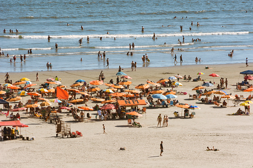 Maspalomas, Spain - December 09, 2023: Beach in Maspalomas crowded with people in winter.