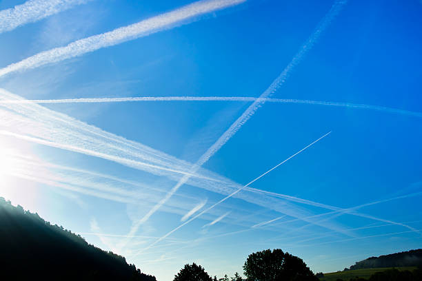 istock vapor stripes on a blue morning sky 157625118