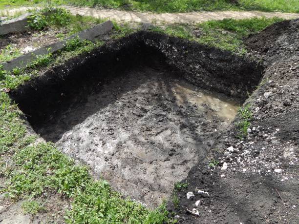istock Deep square trench. A hole dug for a foundation. 1576254483