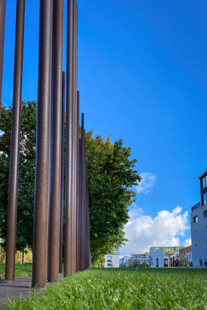 Berlin, Germany - October 13, 2021: Low angle view of vertical iron bars at Berlin Wall Memorial, that commemorates the division of Berlin and shows its former location