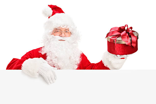 istock Santa Claus behind a billboard holding present 157625668