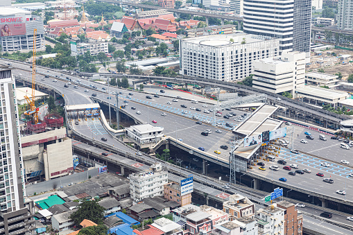 BANGKOK, THAILAND - SEPTEMBER-23-2020 : Aerial view of busy cars with traffic jam in the rush hour on highway road street on bridge in downtown, urban city in Asia. Intersection junction. Toll gate  on Rama 9 Rd. in Bangkok