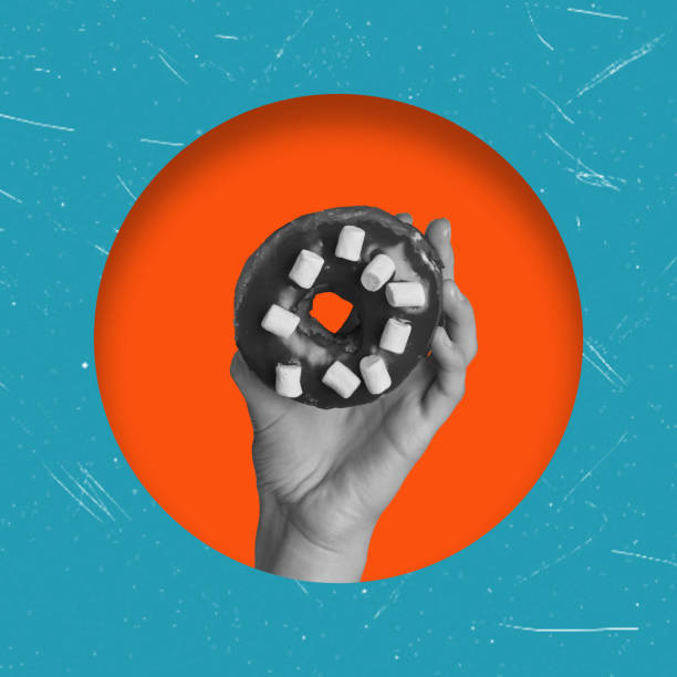 istock Art collage, hand holding a donut, in an orange circle and on a blue background. 1576274930