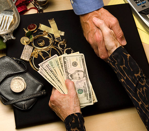 woman selling gold and silver stock photo