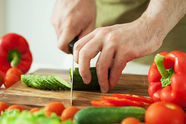 istock man cutting vegetables for salad 157628003