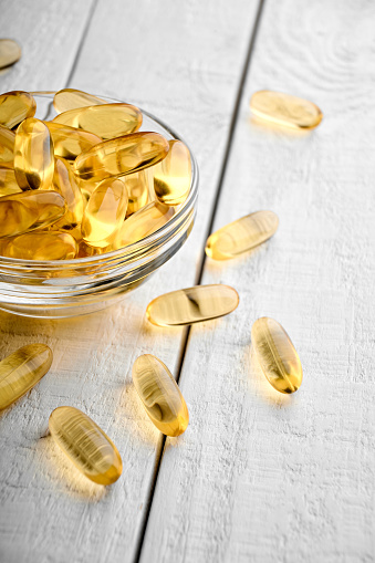 Omega-3 Fish Fat Oil Capsules. Fish oil capsules isolated on white background. Close up of capsules Omega 3 on white background. Health care concept. Nutritional supplements. Vitamins