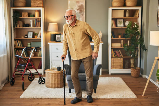 istock Elderly man with walking cane at home 1576304210