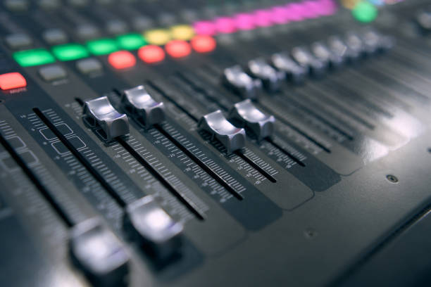 Professional audio mixing console. ​Mixer. Pro audio mixing board faders and knobs. Static shot of multi-track music recording equipment faders and sliders.