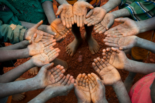 Young Ethiopians form a circle of open hands in a village in southern Ethiopia.