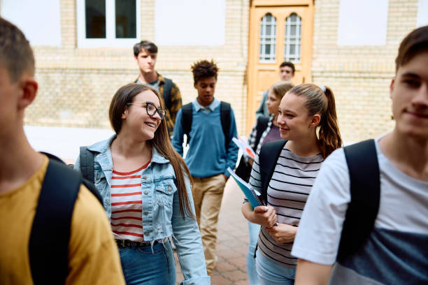 istock Multiracial group of high school students walking in schoolyard after the class. 1576355186