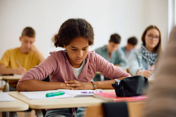 istock Black female student learning in the classroom at high school. 1576356407