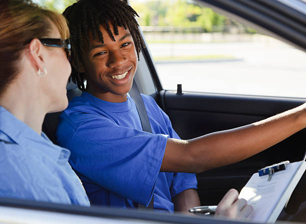Driving Test A teenage boy taking a driving test with the instructor. teenager boy driving stock pictures, royalty-free photos & images