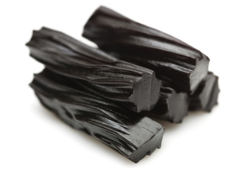 Close-up view of five pieces of licorice on white background