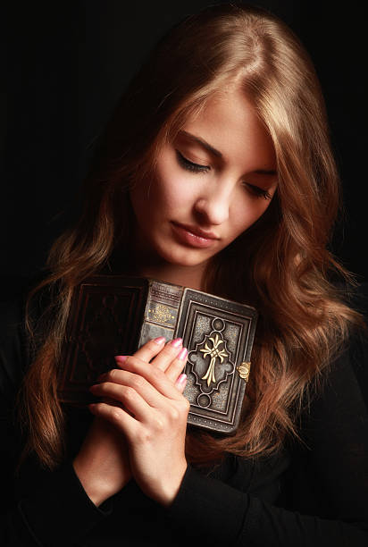 istock Praying catholic girl 157636003