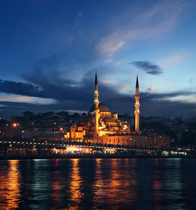 A small group of people walk through the Galata Bridges towards the Sultan Ahmet and Ayasofya