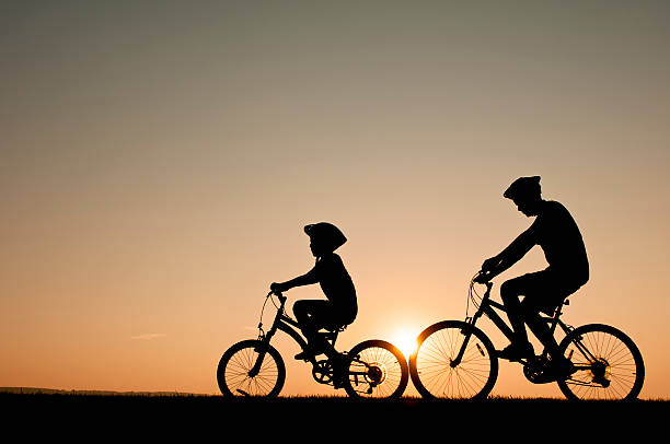 Kids riding their bikes during a summer evening - I stock photo