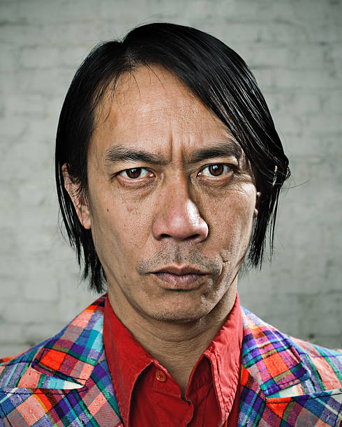 Serious man with weird suit Serious asian man with weird suit. ugly face stock pictures, royalty-free photos & images