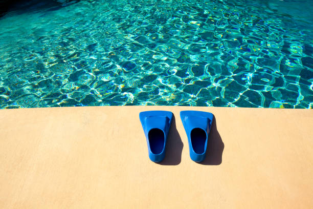 couple having fun at the swimming pool diving