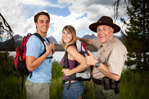 Ranger Helps Lost Campers. This stock image has a horizontal composition.