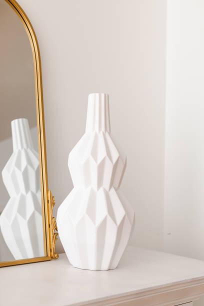 istock White porcelain vase on a mantel 1576364590