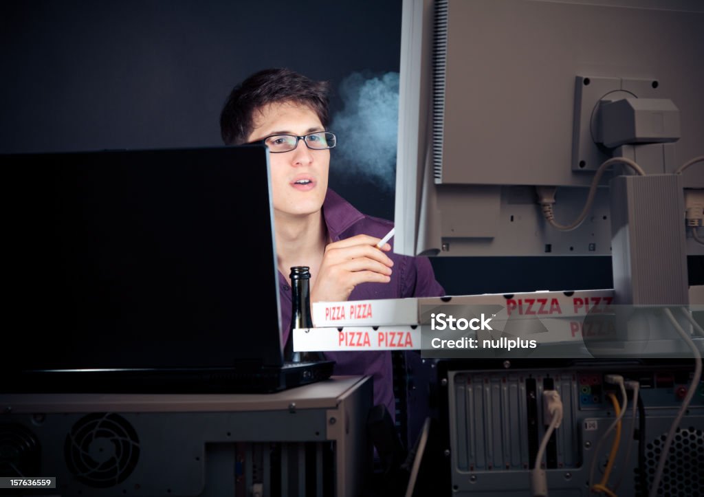 young man spending his night with computers nerd sitting in front of his computers all night long 20-29 Years Stock Photo