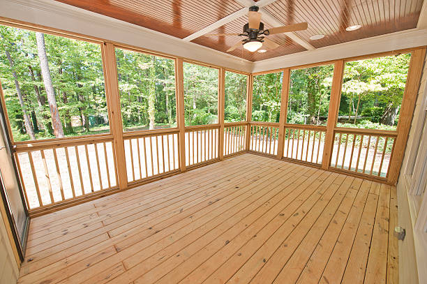 istock Empty, wooden rear patio with fan, lights and large windows 157636735