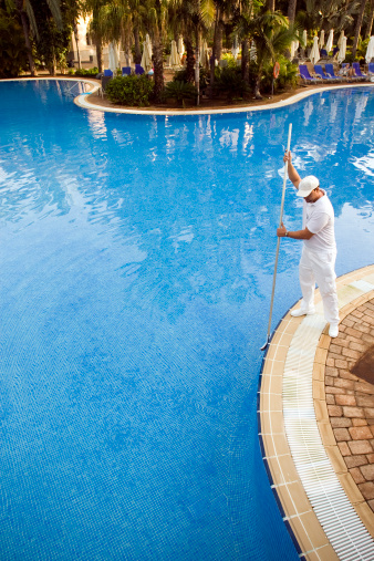 Image of a worker doing early morning cleaning of a resort pool (ISO 100). All my images have been processed in 16 Bits and transfer down to 8 before uploading.