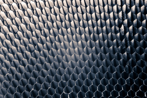 Studio close-up of a honey-comb metal panel, light-weight, sturdy and flexible.
