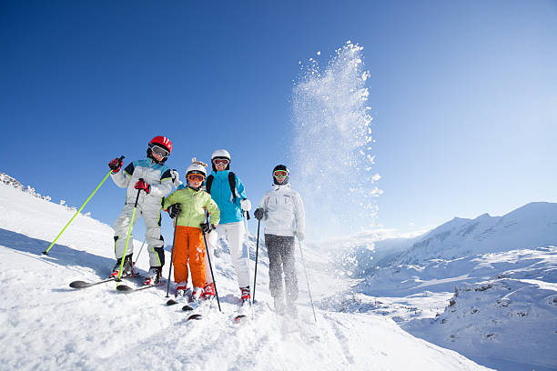 family on skis at blue sky