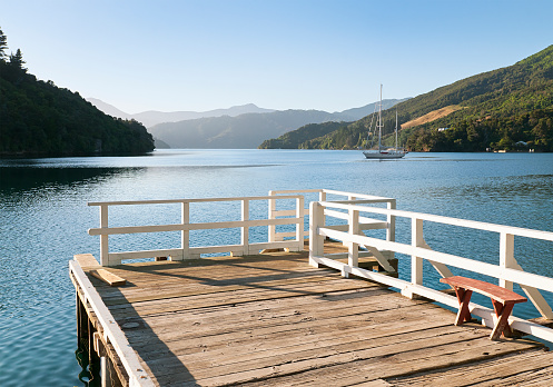 A peaceful late evening on a  wooden jetty in Mistletoe Bay, Queen Charlotte Sound in New Zealand's Marlborough Sounds.