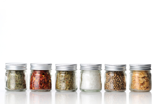 variety of spices, garlic flakes, rosemary flakes, bay leaves, coriander seeds, rosemary flakes, chili flakes and salt