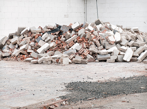 A pile of old damaged bricks and concrete blocks.