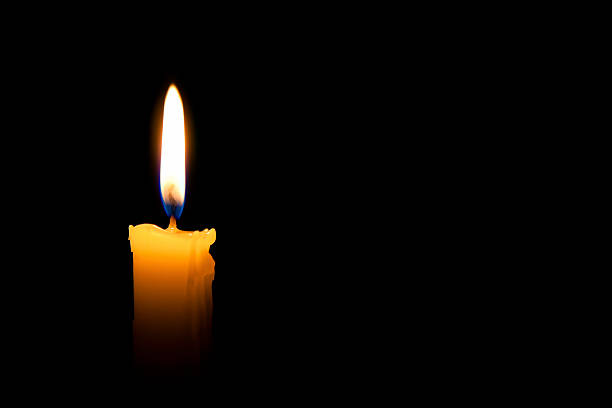 Single lit candle with quite flame stock photo