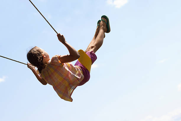 Cute Girl Swinging High in Air 2 stock photo