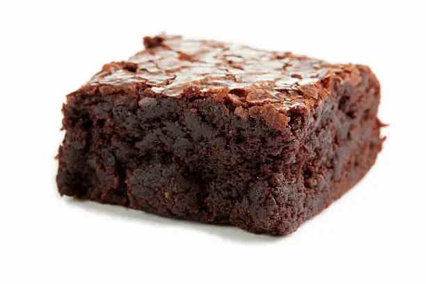 Freshly baked chocolate brownie isolated on white.