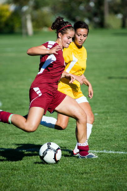 istock Female Soccer Player Breaks Away From Defender 157638039