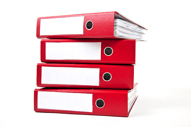 Stack of four red ring binders with spine facing viewer stock photo