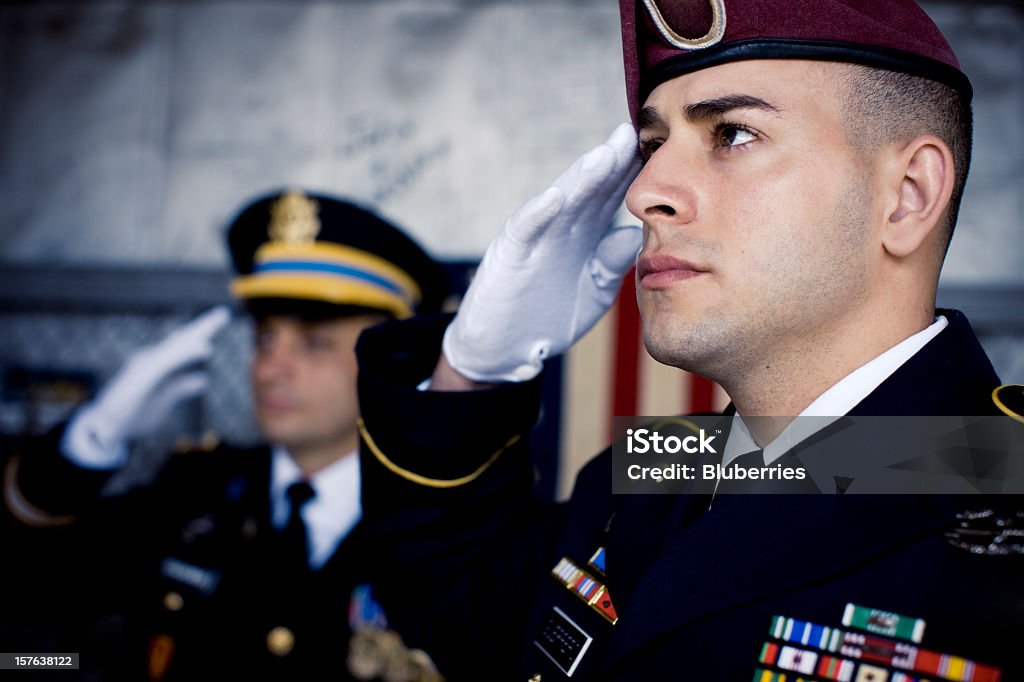 Soldier's Salute Soldiers standing in uniform, saluting. Saluting Stock Photo