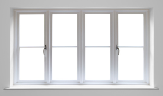 very high quality manufactured wooden window frames with double glazed units set in a recess surrounded by a light grey wall. 