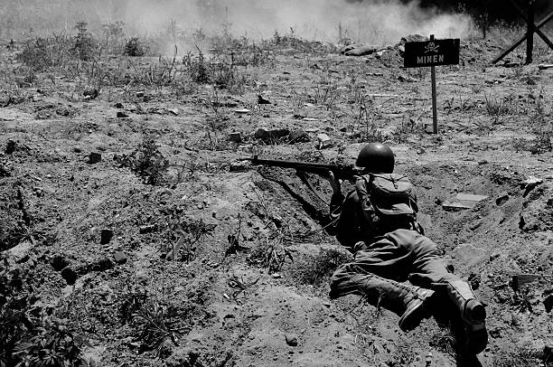 World War 2 D-Day Military Reenactment Soldier Grained Black White B&W image from D-Day landing reenactment.  Teenage reenactor soldier.  RAW source image taken June 6, 2010. world war ii photos stock pictures, royalty-free photos & images