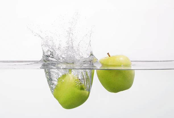 2 apples splashing into the water