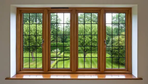 Photo of Garden view through leaded glass window