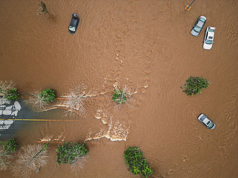Looking down on a cars in a flooded parking lot.