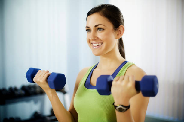 istock Young Woman Doing Arm Curls With Dumbbells 157639012