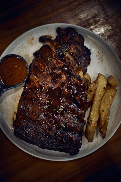 istock Caramelised BBQ Pork Spare Ribs and Potato Wedges 1576390529