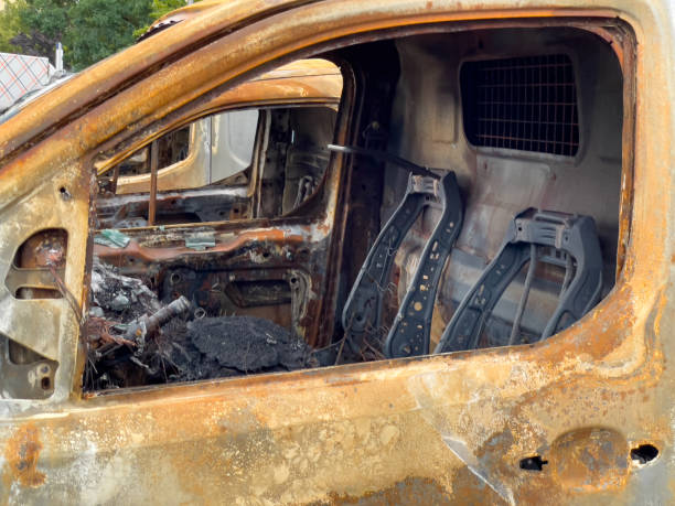 istock Burnt out cars in a parking space. 1576390763